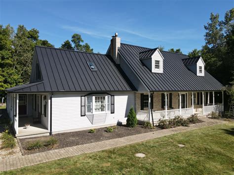 white brick house black metal roof|brick house exterior black roof.